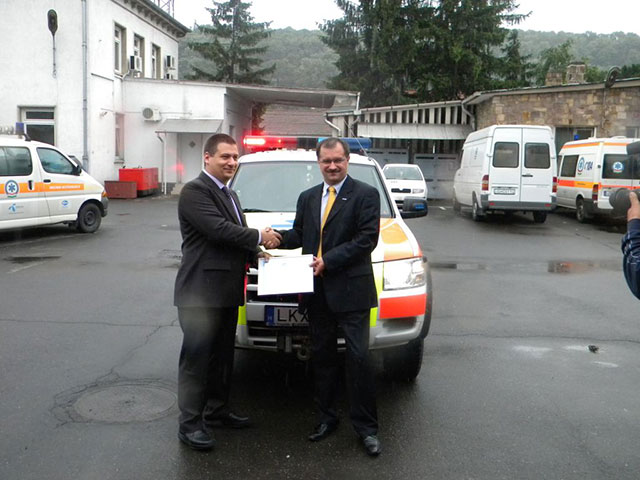 László Endre Márton átveszi az egymillió forintos adományt jelképező emléklapot Kovács Imrétől